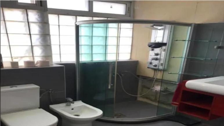 a bathroom with a shower and a toilet and a sink at Yalla Hostel in Ramallah