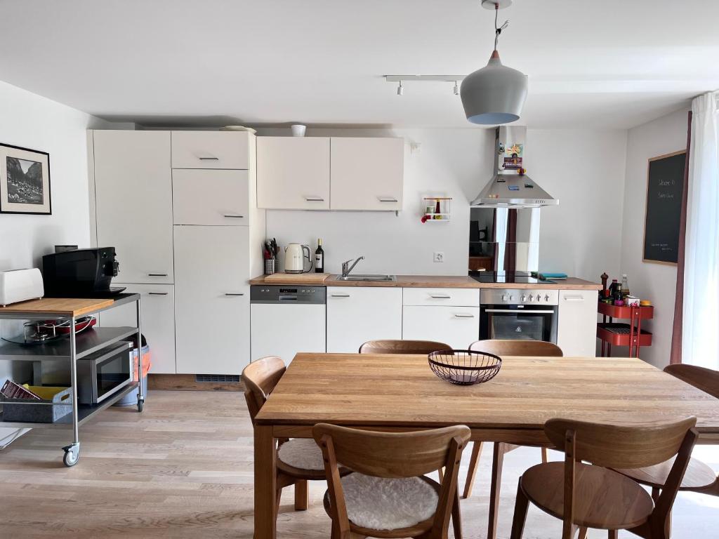 a kitchen with a table and chairs in a room at apartment Alpenrose in Saas-Grund