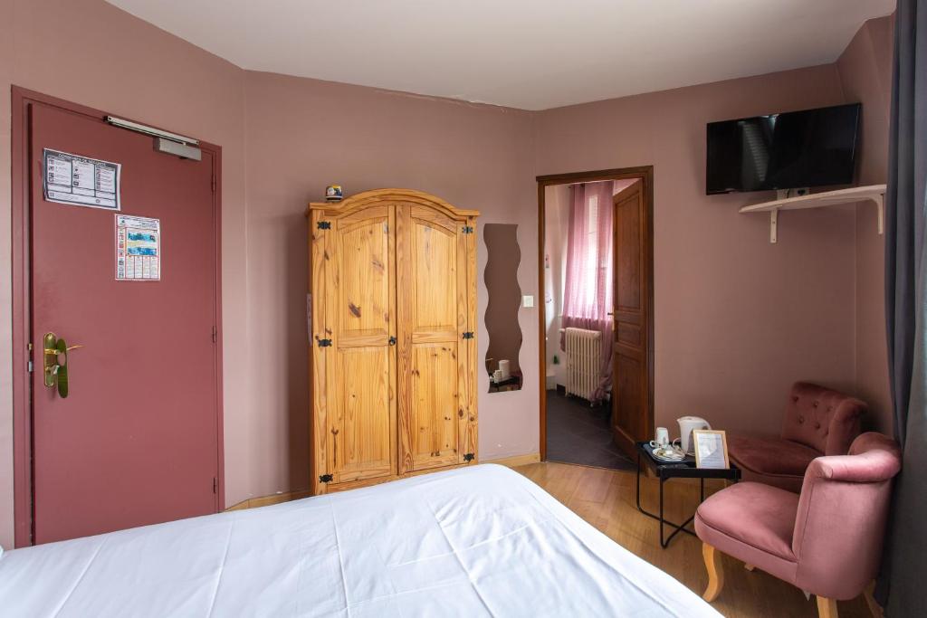 Postel nebo postele na pokoji v ubytování L'abbatiale