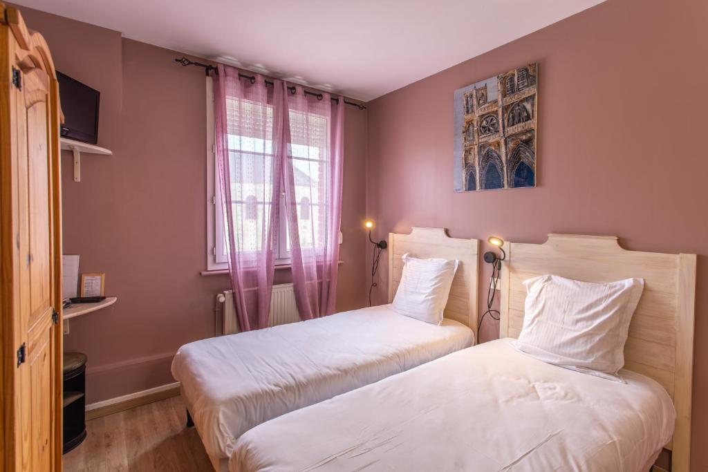 Postel nebo postele na pokoji v ubytování L'abbatiale