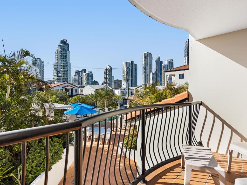 a balcony with a chair and a view of the city at Chevron Palms by Gold Coast Premium in Gold Coast