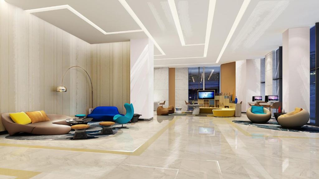 a lobby with couches and chairs in a building at Holiday Inn Express - Liuyang Development Zone, an IHG Hotel in Liuyang