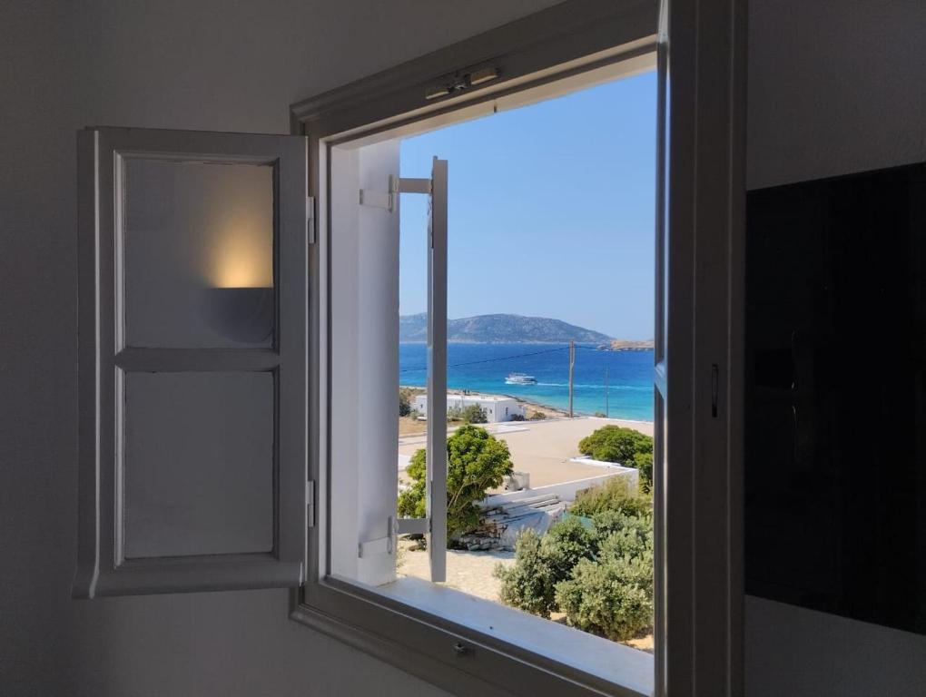 a window with a view of a beach at Paradise Hotel in Koufonisia