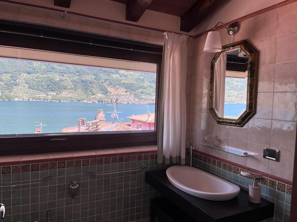 a bathroom with a sink and a large window at Villetta la Colombaia in Carzano