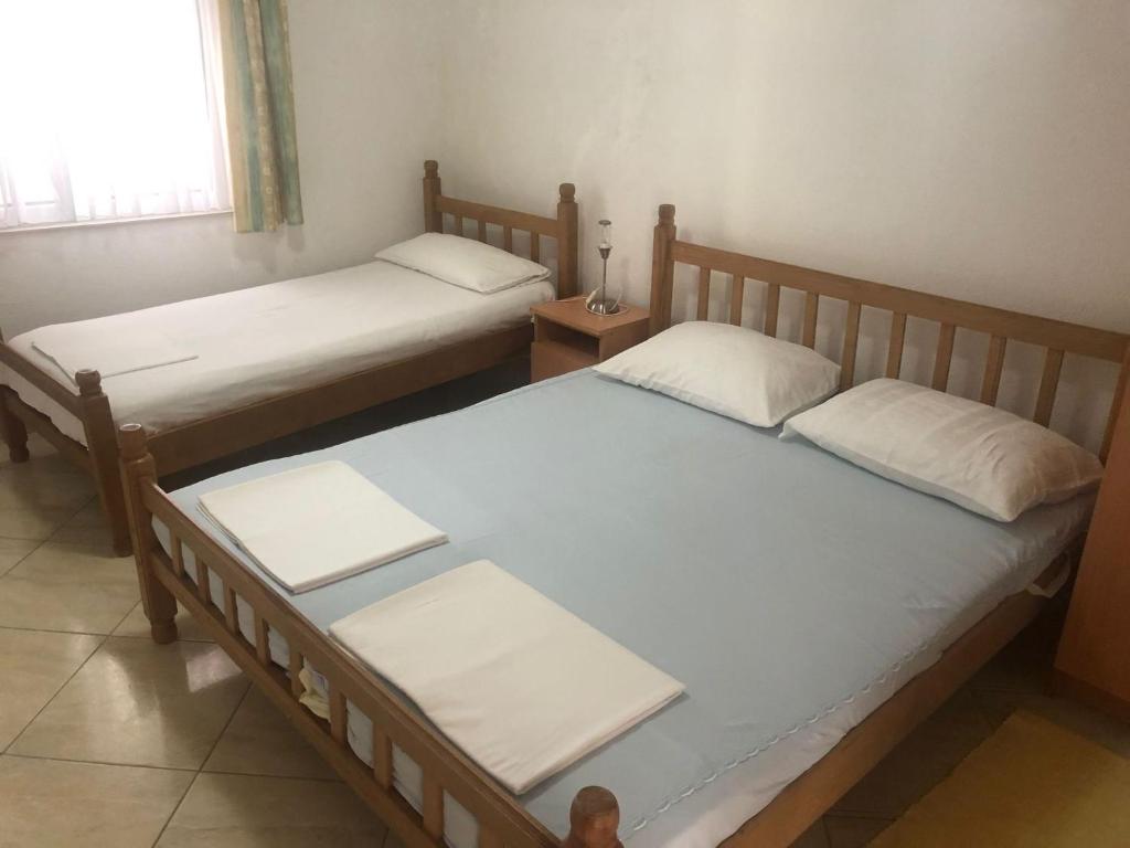 two twin beds in a room with a window at Nafija in Donji Štoj