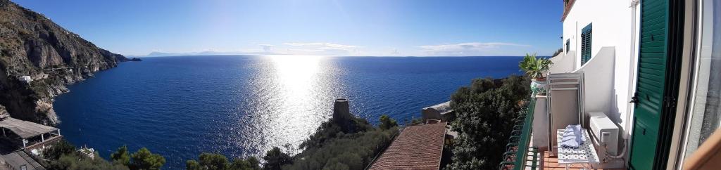 a view of a large body of water between buildings at Hotel La Perla in Praiano