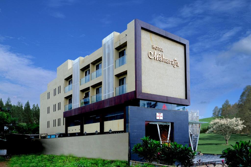 a building with a large sign in front of it at Hotel Maharaja in Nashik