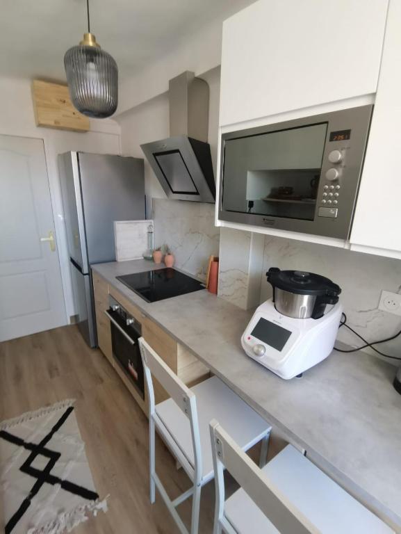 a kitchen with a counter with a mixer and a microwave at Massilia Calling love Appartement de standing 8 personnes Marseille proche métro parking facile in Marseille
