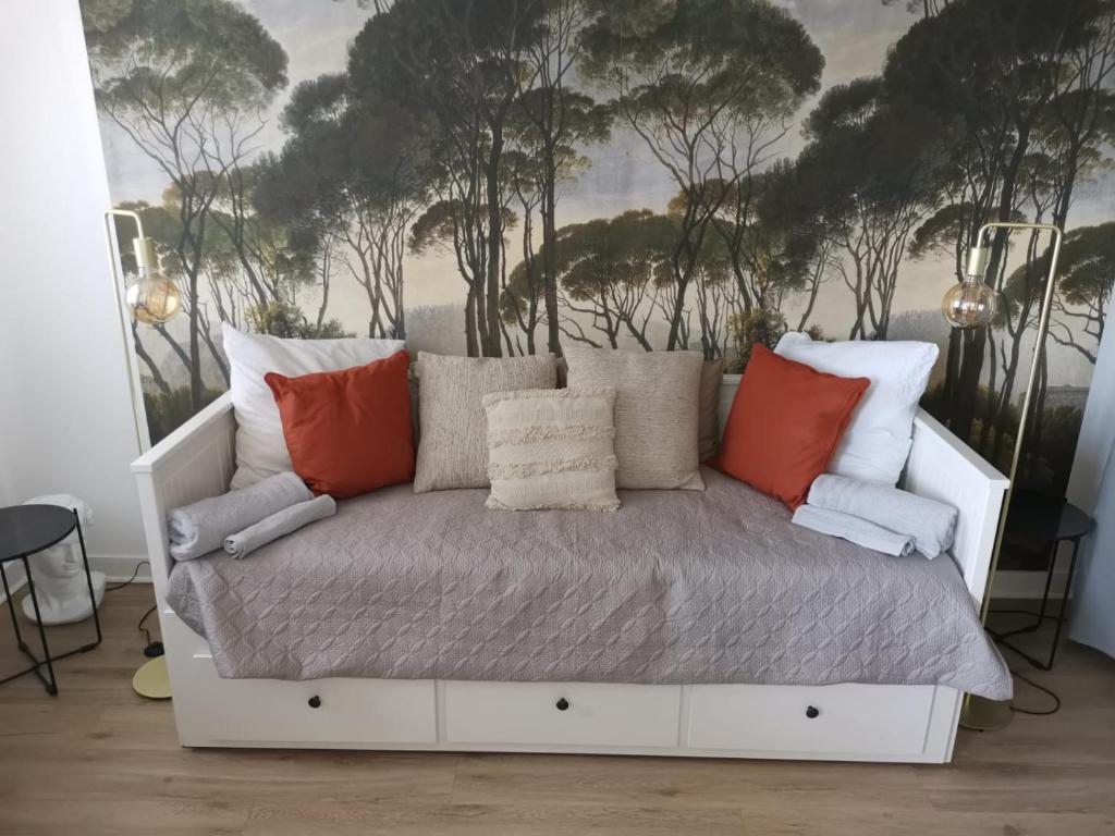 a white bed in a room with trees in the background at Massilia Calling love Appartement de standing 8 personnes Marseille proche métro parking facile in Marseille