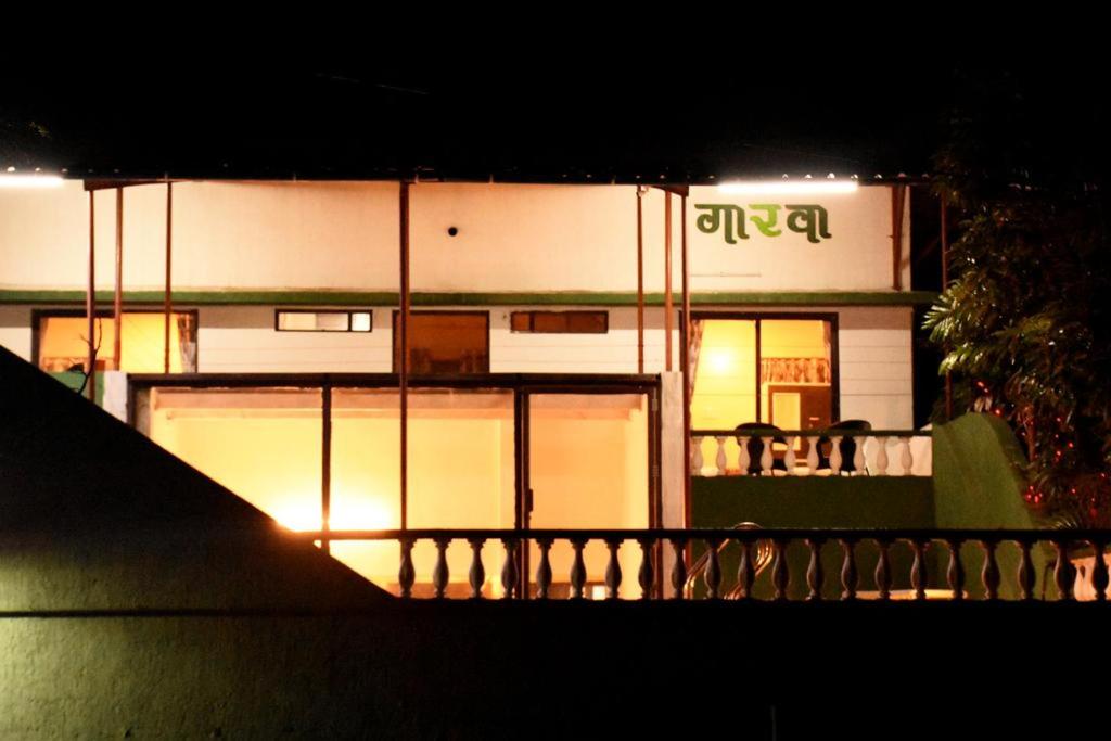 a building at night with lights in the windows at Garava Villa Lonavala in Khandala