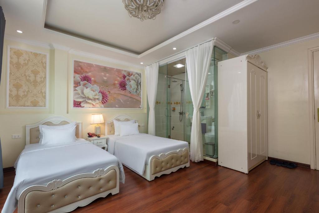 Postel nebo postele na pokoji v ubytování My Moon Hotel Hanoi