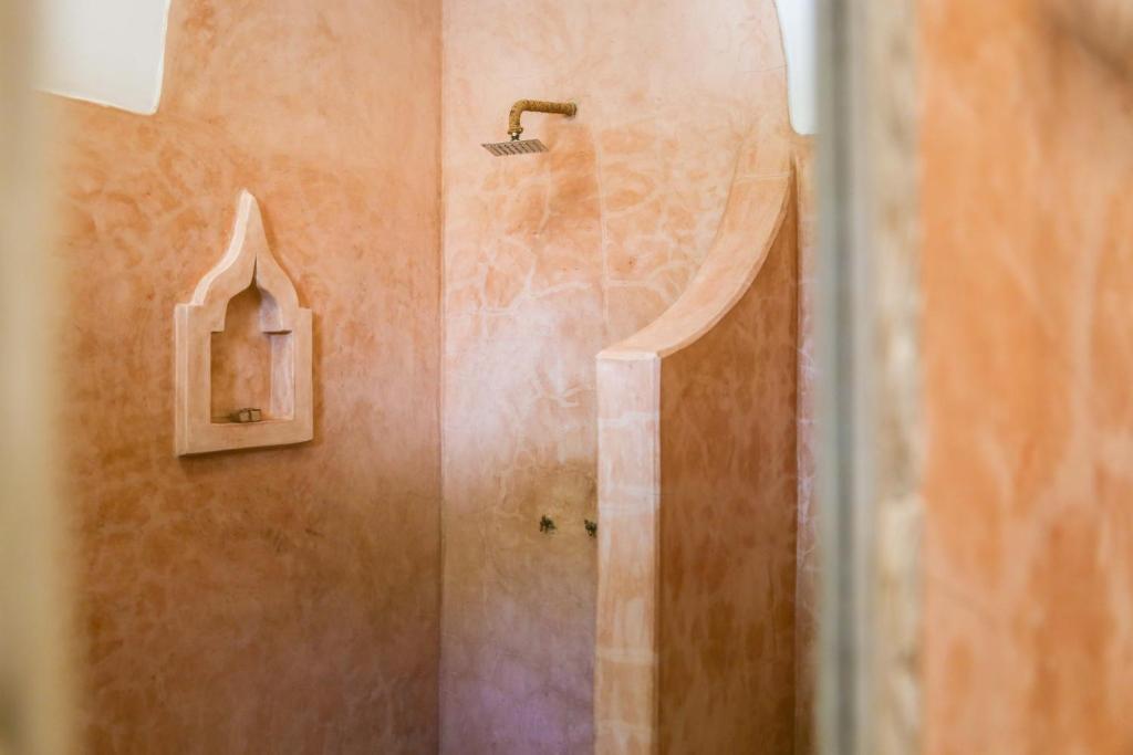 a shower in a bathroom with a shower at Mr Kahawa Waterfront Suites in Paje