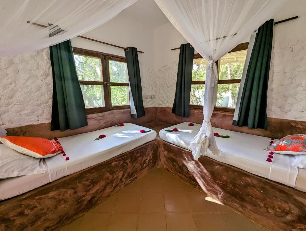 Postel nebo postele na pokoji v ubytování Bahati Villa