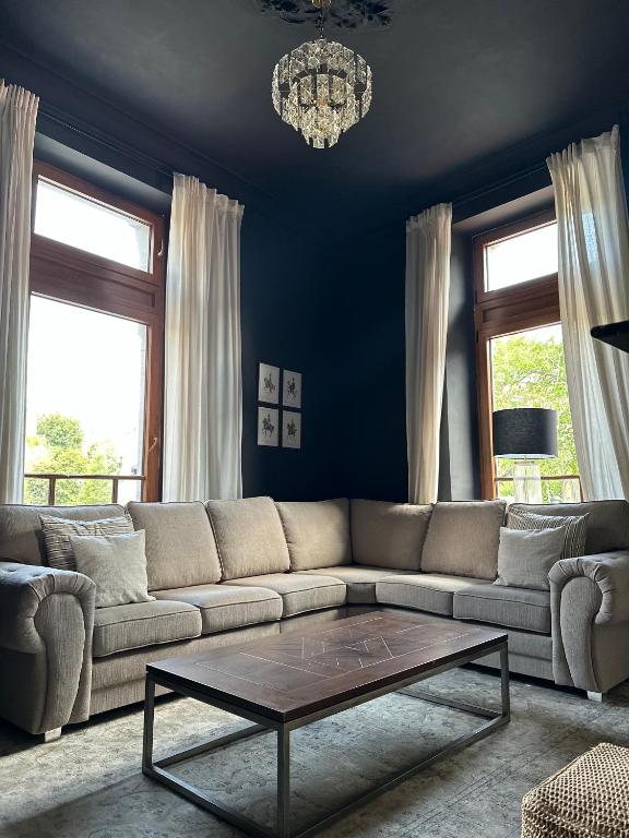 a living room with a couch and a coffee table at Maison Comtale in Rochefort