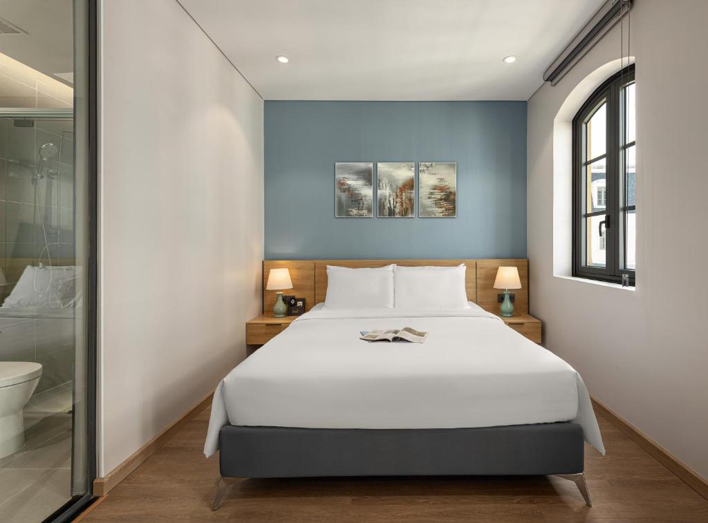 Postel nebo postele na pokoji v ubytování Laputa Hotel Phu Quoc