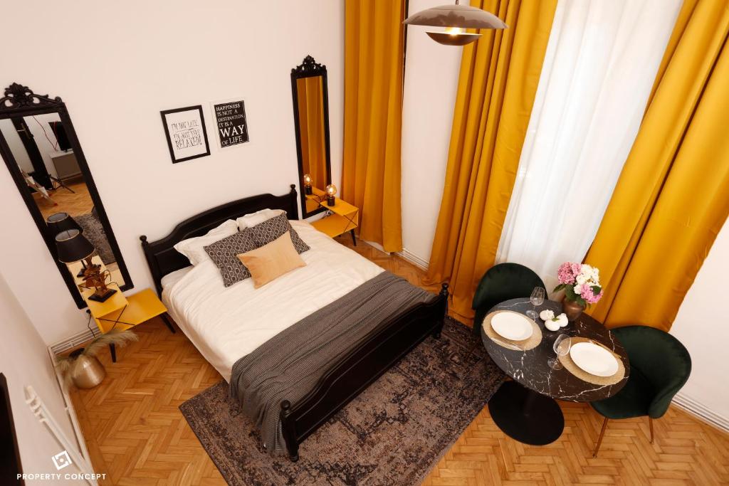 um quarto com uma cama e uma mesa em Bohemian Central Concept Studio em Bucareste