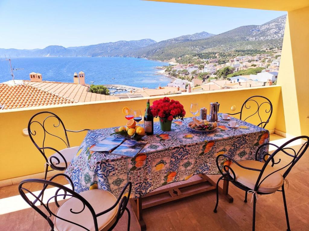 comedor con mesa y vistas al océano en Appartamento Neruda, en Cala Gonone