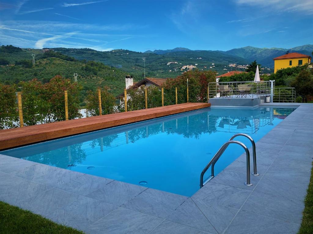 a swimming pool with a view of the mountains at Agriturismo Benza in Imperia