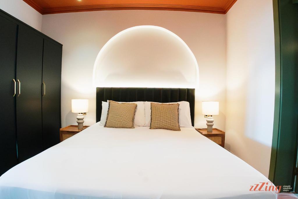 a bedroom with a large white bed and two lamps at A luxury apartment in Malta’s capital Valletta in Valletta