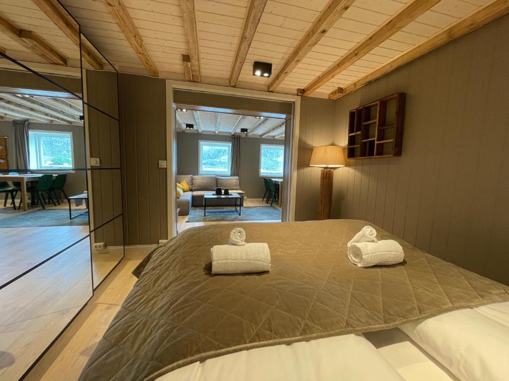 a bedroom with a large bed with two pillows on it at Lofoten Planet Studio in Sørvågen