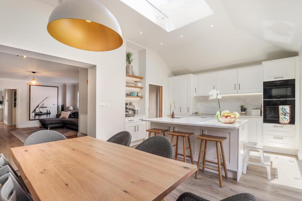 a kitchen and dining room with a wooden table and chairs at Pass the Keys Perfectly presented house in Sevenoaks