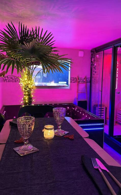 a table in a restaurant with a purple room at BIOTY CHILL &amp; SPA in Le Blanc-Mesnil