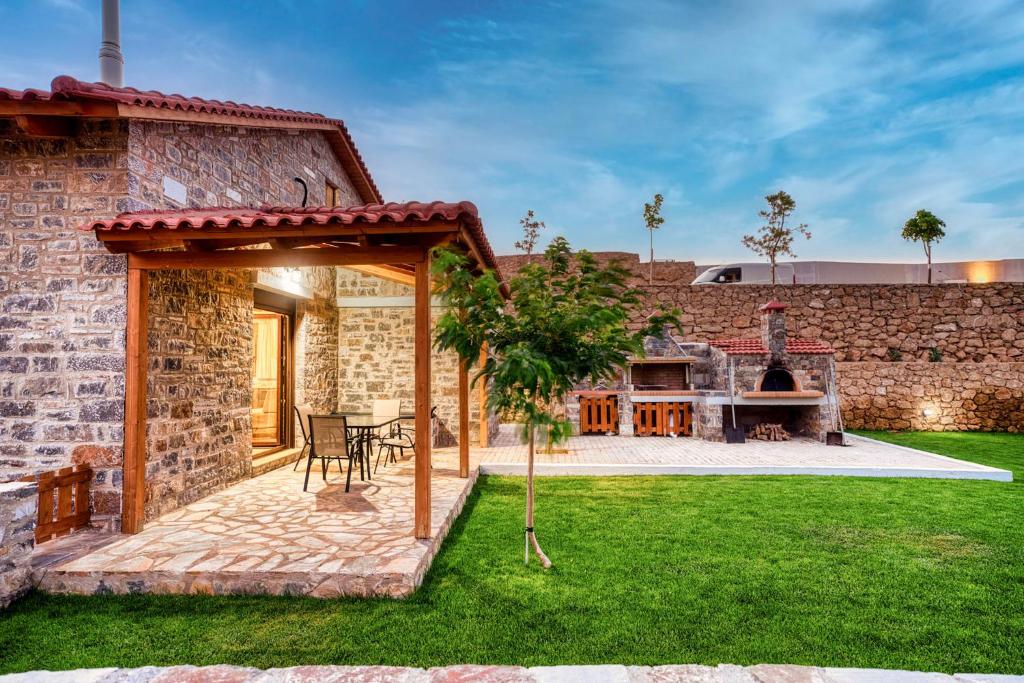 een stenen huis met een tuin en een patio bij Cloud 9 with Garden near the Sea in Agia Pelagia