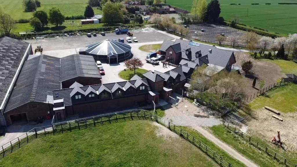 an overhead view of a large building with a tent at Falabella Suite with amazing views of stud farm. in Great Driffield