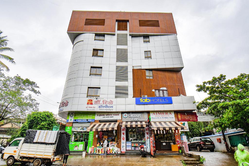 a tall building with a store in front of it at FabHotel The Address in Nashik