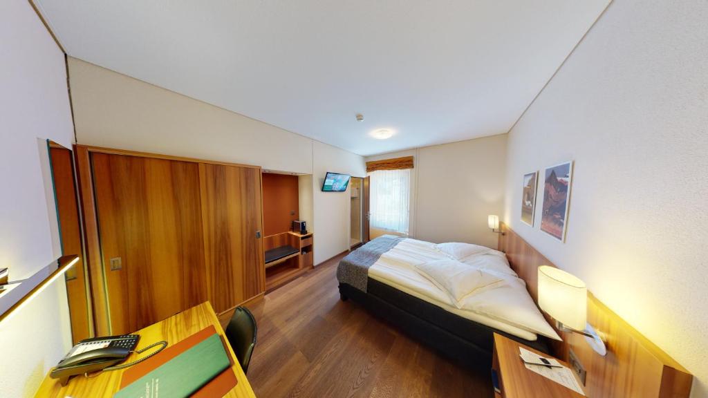 Postel nebo postele na pokoji v ubytování Hotel Ambassador