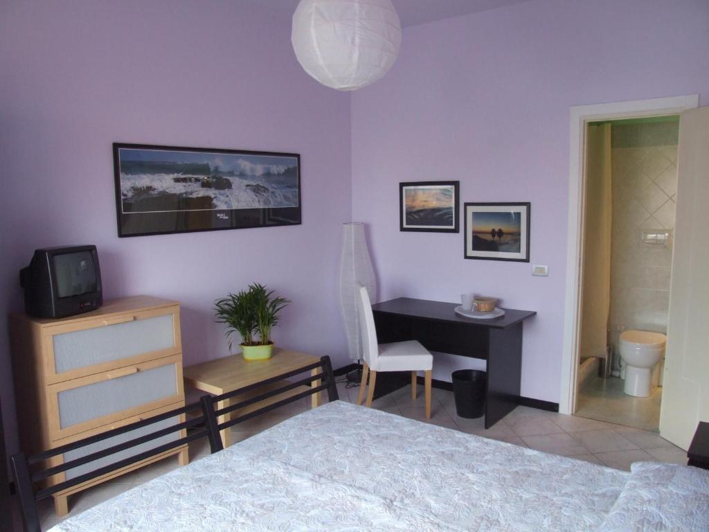 1 dormitorio con 1 cama y escritorio con TV en Cà dell'Angelo, en Canegrate