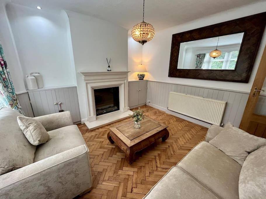 a living room with a couch and a coffee table at Spacious Family home in Cardiff with Parking! in Cardiff