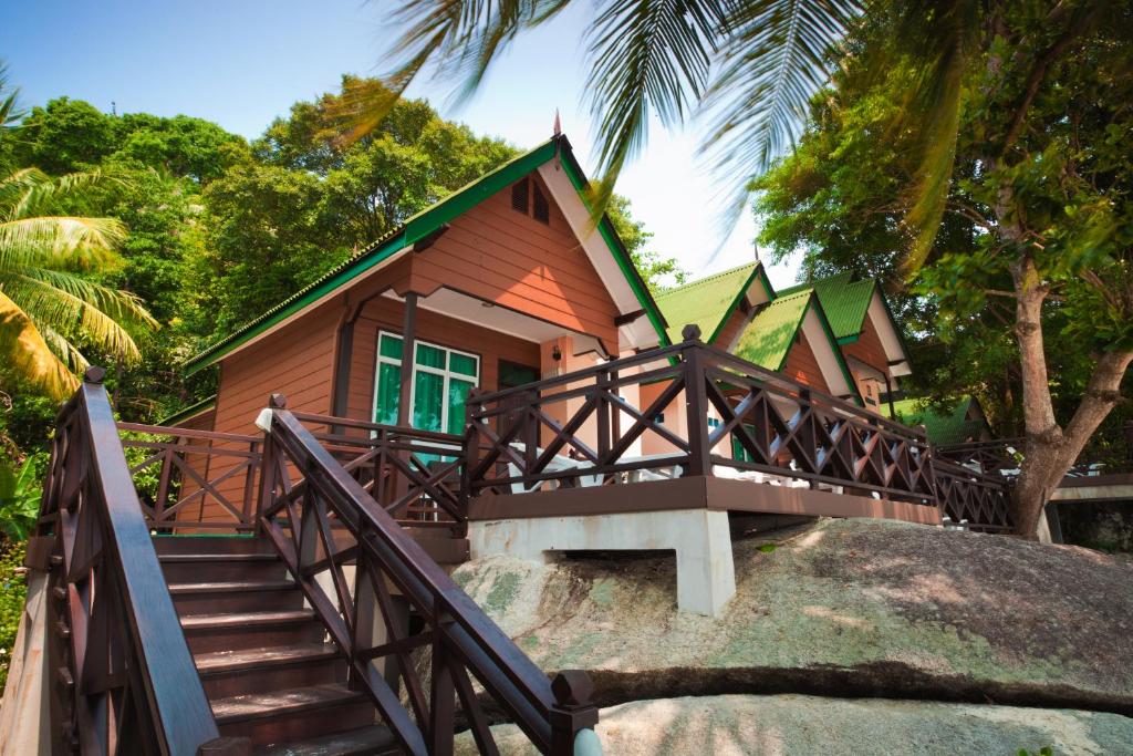 a small house with stairs leading up to it at Tuna Bay Island Resort in Perhentian Islands