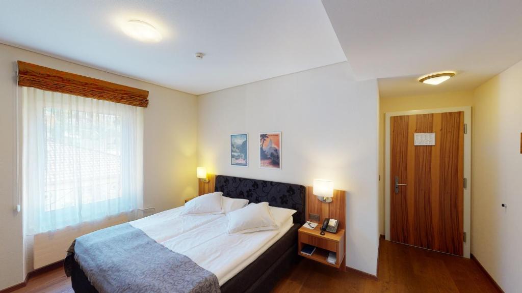 Postel nebo postele na pokoji v ubytování Hotel Ambassador
