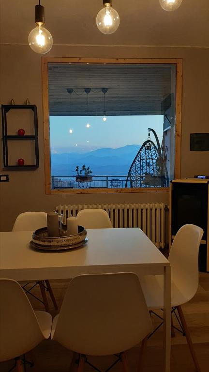 a dining room table with chairs and a view of the ocean at Peter Pan in Castellino Tanaro