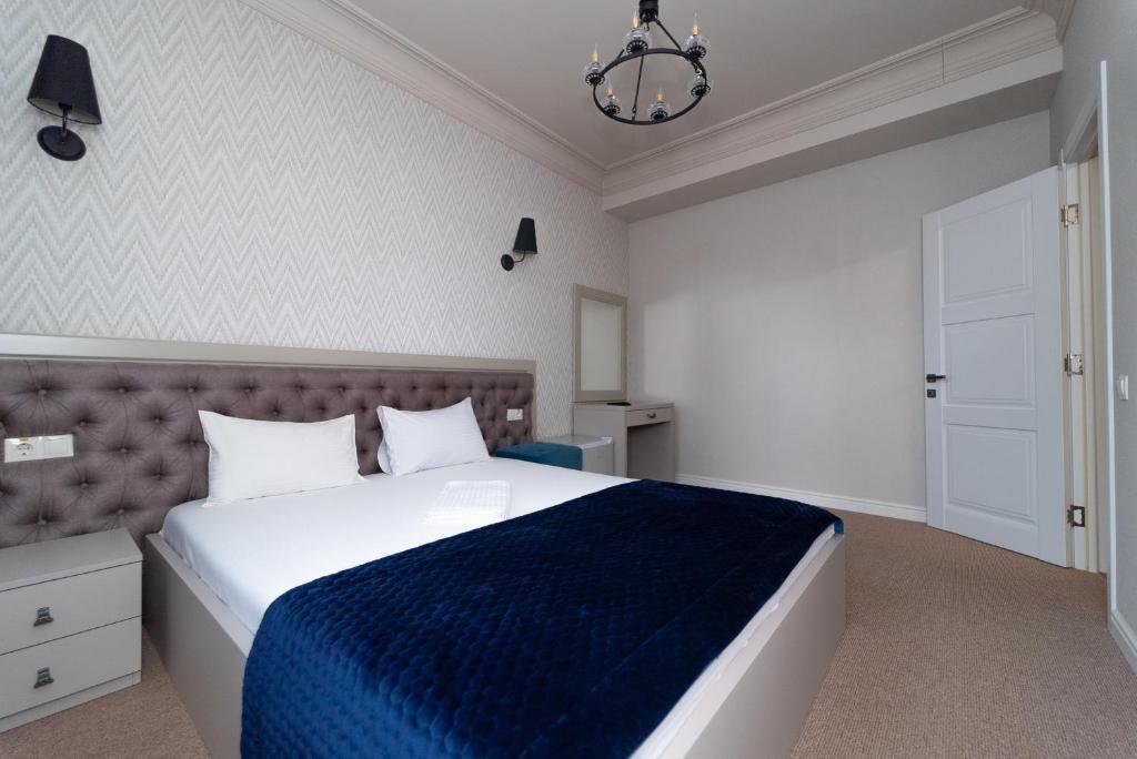 Postel nebo postele na pokoji v ubytování Maner hotel