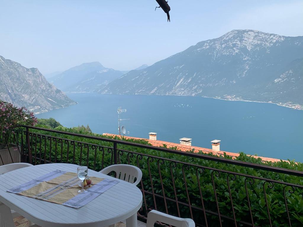 a table on a balcony with a view of a lake at Casa Eulberg Marcania Balcone vista lago in Tremosine Sul Garda
