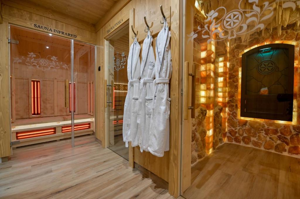 a room with a display of white clothes on a wall at Pod Tatrami 1 - świetna lokalizacja - sauna infared oraz grota solna - jedno wejście gratis in Białka Tatrzańska