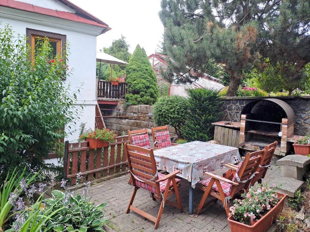 a patio with a table and chairs and a pizza oven at Kamélie in Česká Kamenice