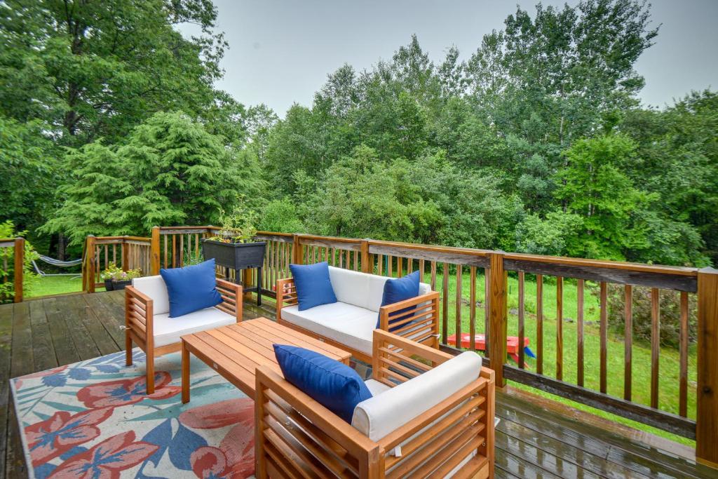 a patio with two chairs and a table on a deck at Alexandria Cabin with Patio, Grill and Deck 
