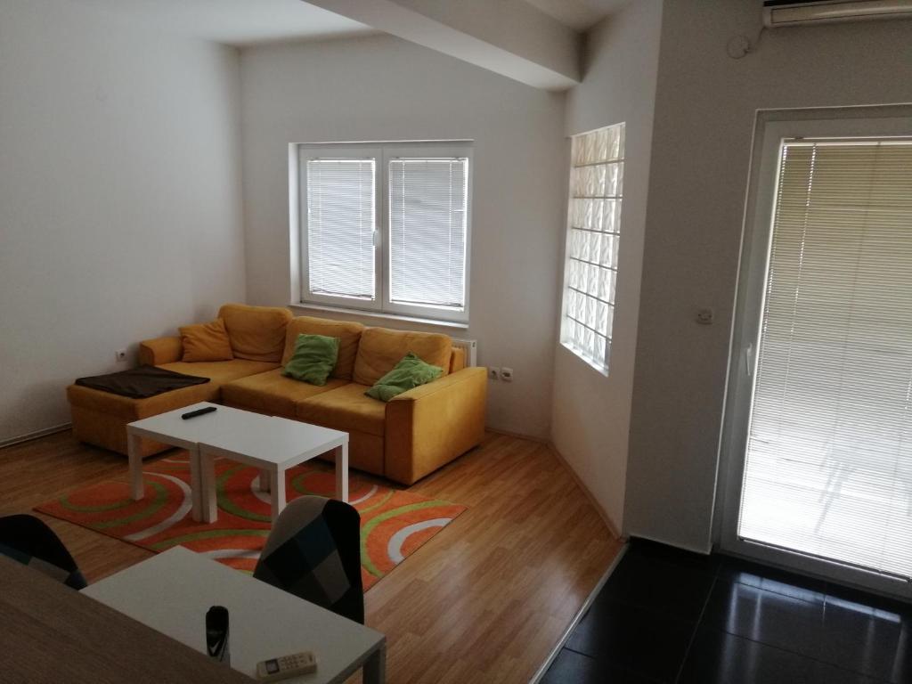 a living room with a couch and a table at One bedroom apartment-Centar in Kavadarci