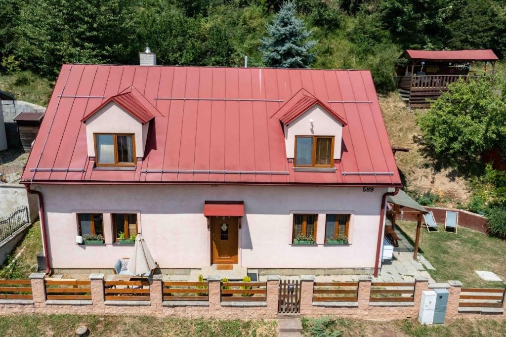 a house with a red roof on top of it at Apartmány v Müllerovom dome in Banská Štiavnica