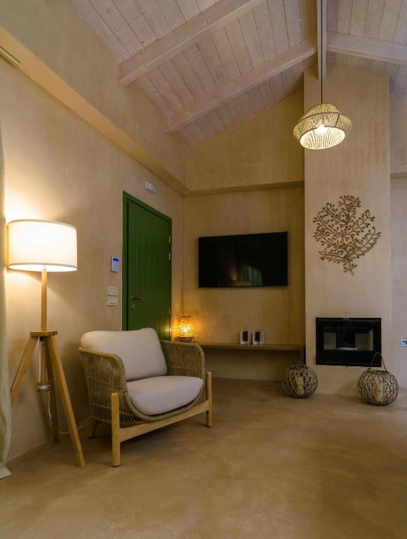 TV a/nebo společenská místnost v ubytování Terra Oleana Cottages