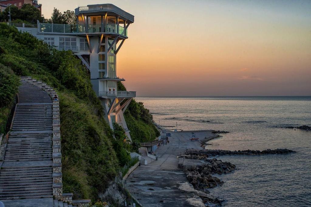 a building on top of a hill next to the ocean at La Pinetina in Ancona