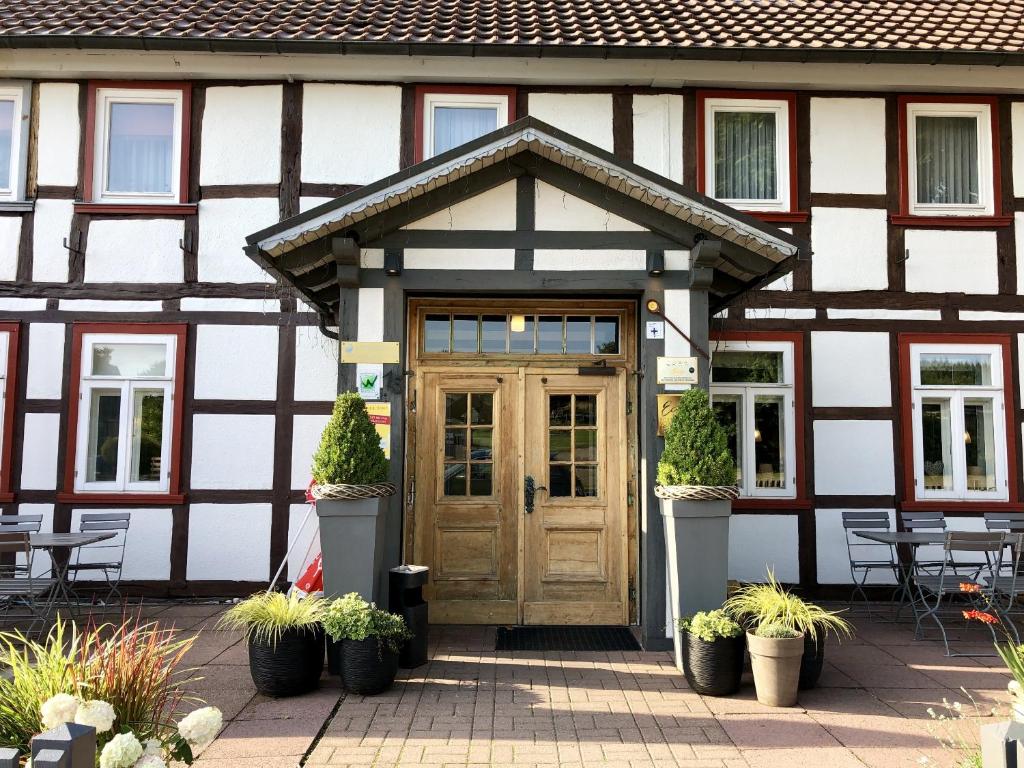 a building with a wooden door and some plants at Landhaus Sollingshöhe in Holzminden