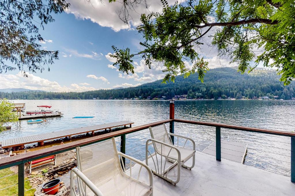 a deck of a boat on a lake at Bottle Bay Bungalow in Sagle