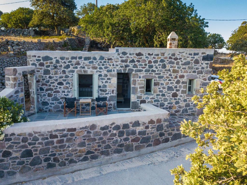 a stone building with a table and chairs on it at Apostrophe Traditional Residence in Nisyros with arcurated interior. Privacy & Authenticity in Emporeiós