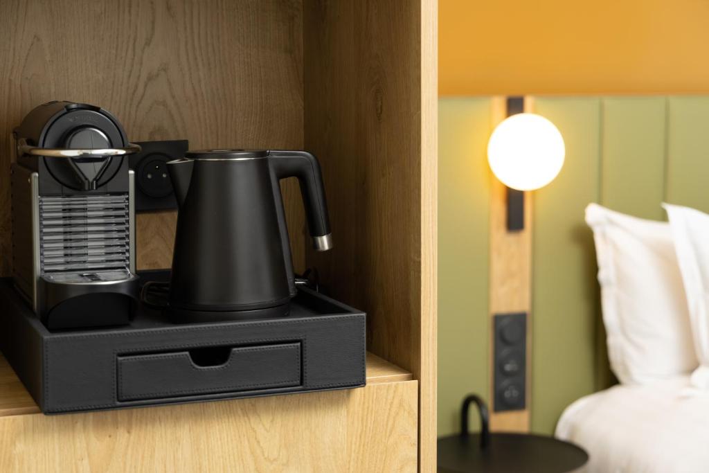 a black coffee maker in a hotel room at Residence Inn by Marriott Paris Didot Montparnasse in Paris
