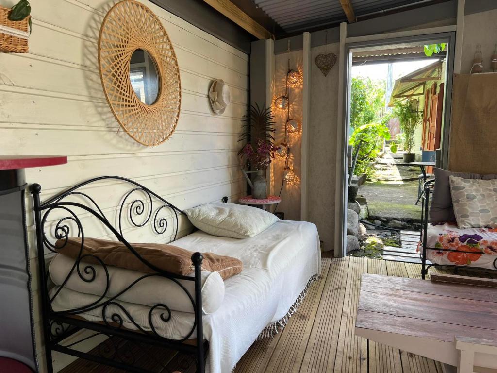 una camera da letto con un letto con specchio e un tavolo di La Kaz LANGEVIN a Saint-Joseph