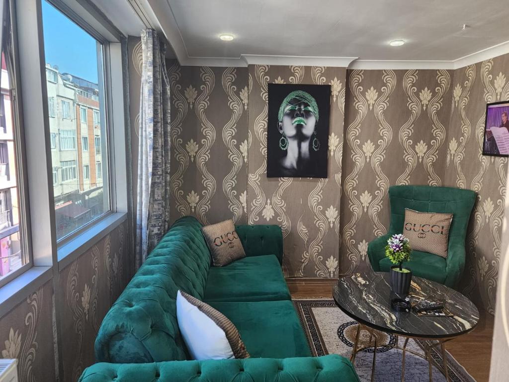 un soggiorno con divano verde e tavolo di Lara Suits & Hotel a Istanbul